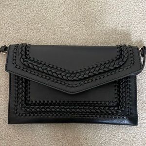 Cute black bag with whipstitch details. Gold hardware.